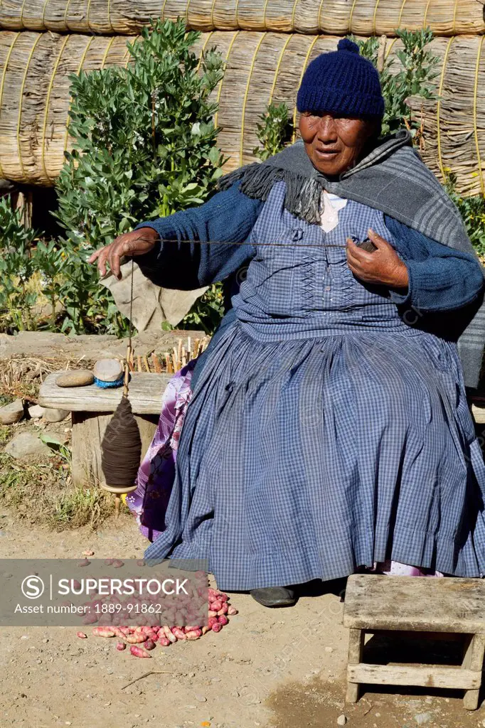 Aymara woman spinning wool, Huatajata, Titicaca Lake, Bolivia