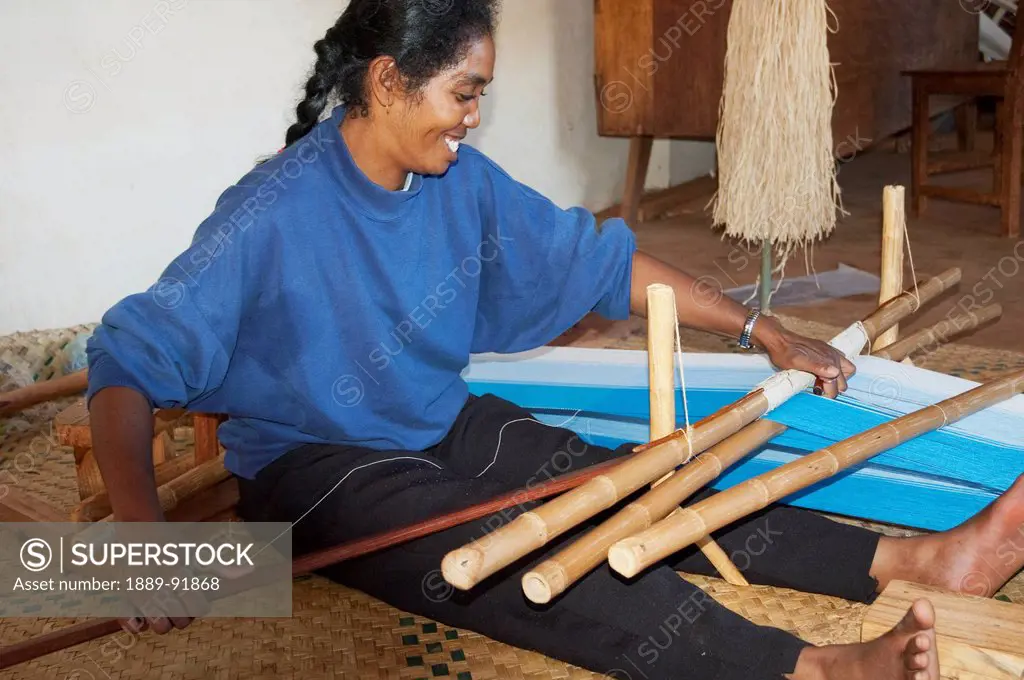 Woman weaving silk at the Fabrique de Papier Antaimoro, Ambalavao, Fianarantsoa Province, Madagascar