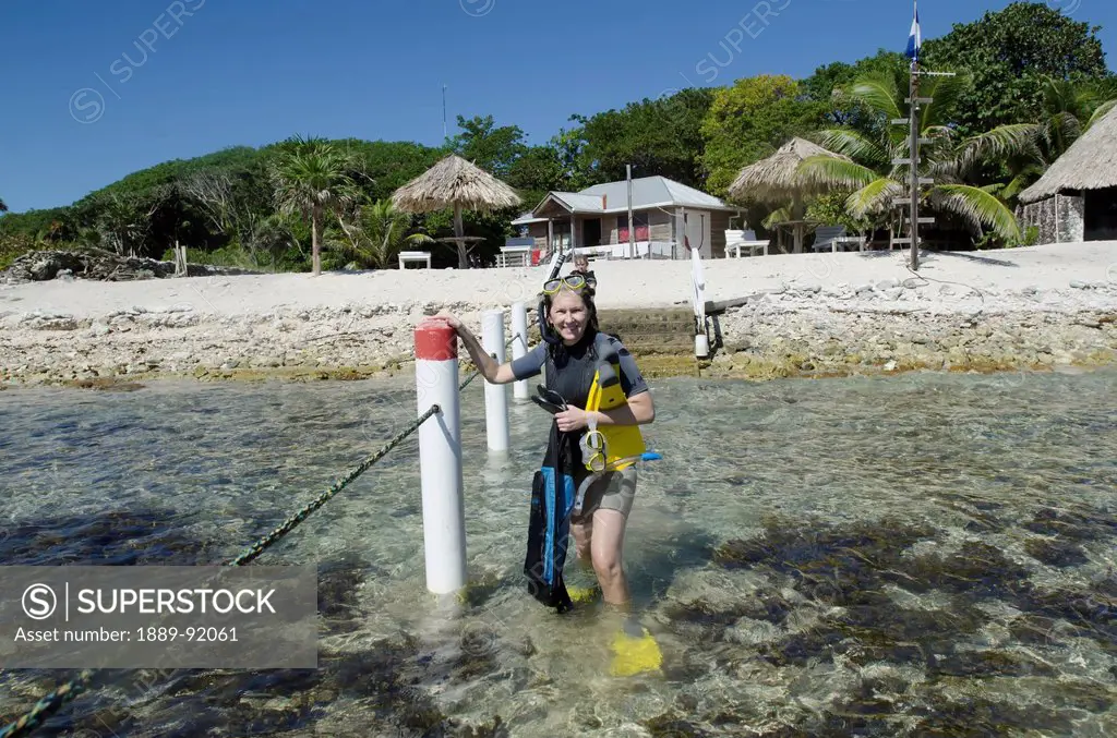 A Woman With Snorkelling Gear At Utopia Village; Utila Island, Honduras