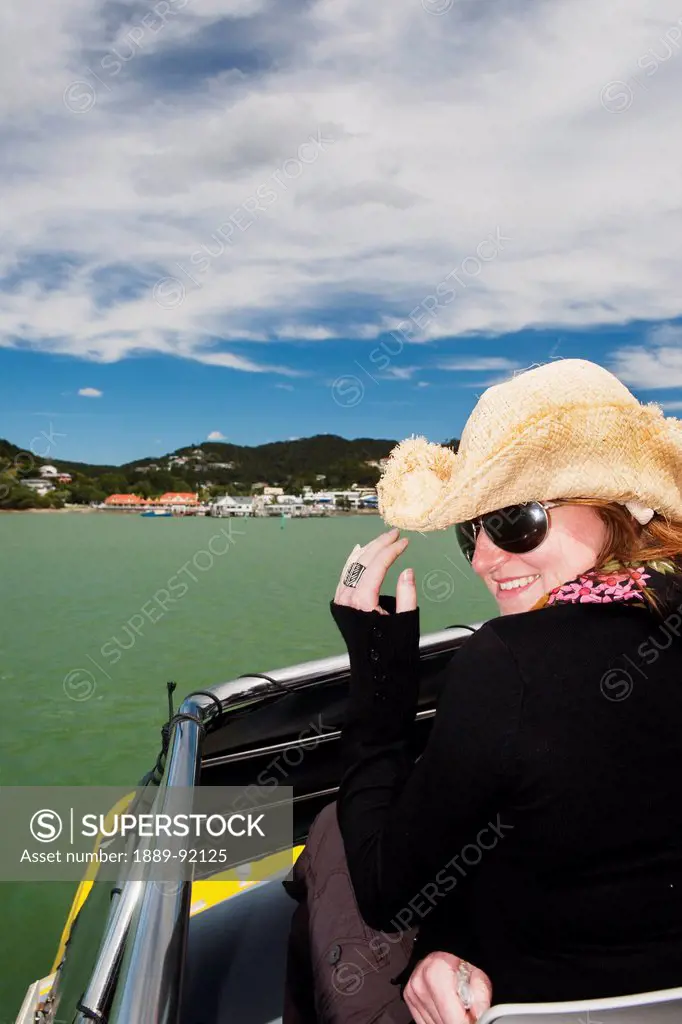 A Girl Holds Her Cowboy Hat On A Boat Cruise From Russell To Paihia; New Zealand