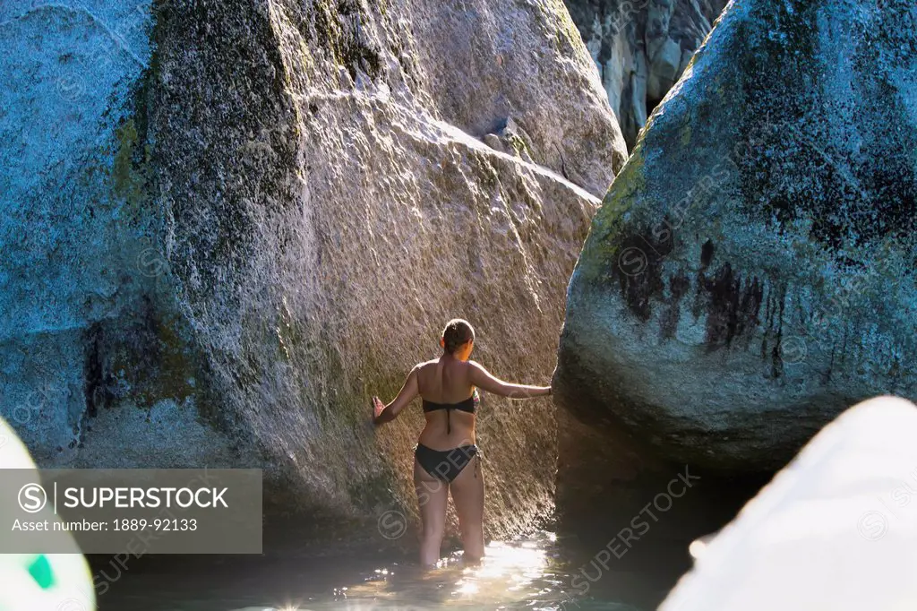 A Girl Wades In The Water At Split Apple Rock In The Abel Tasman National Park; New Zealand