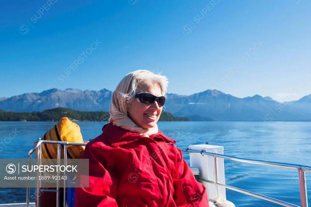 A Traveler Enjoying A Scenic Boat Cruise On Lake Manapouri To Doubtful Sound; New Zealand
