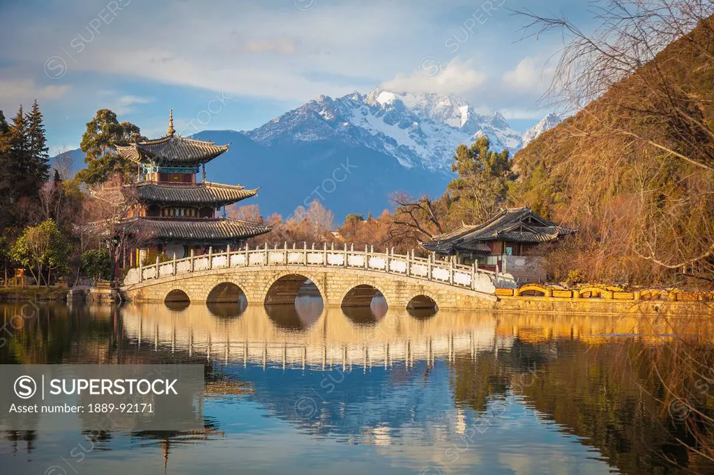 Black Dragon Pool With Jade Dragon Snow Mountain In Background; Lijiang, Yunnan Province, China