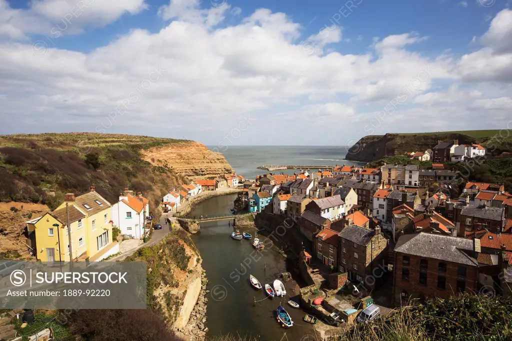 Boats in the river and rooftops; Staithes, North Yorkshire, England