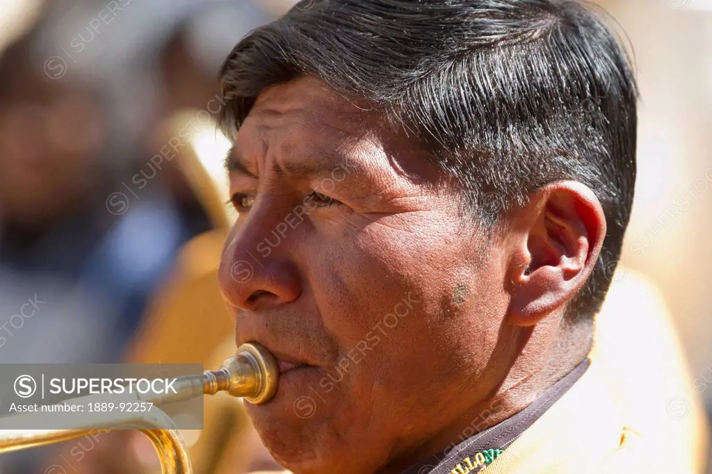 Trumpet player of a brass band in a Preste procession through the streets of La Paz, Bolivia