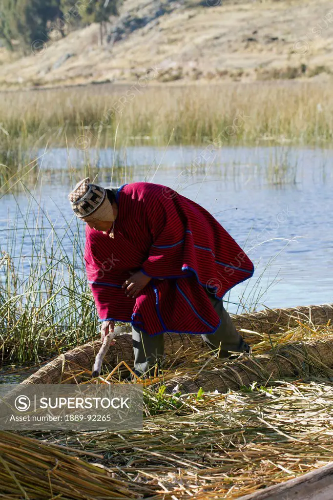 Urus Iruitos man on Chisawa, a reed island made by the Urus Iruitos people in Titicaca Lake, Bolivia