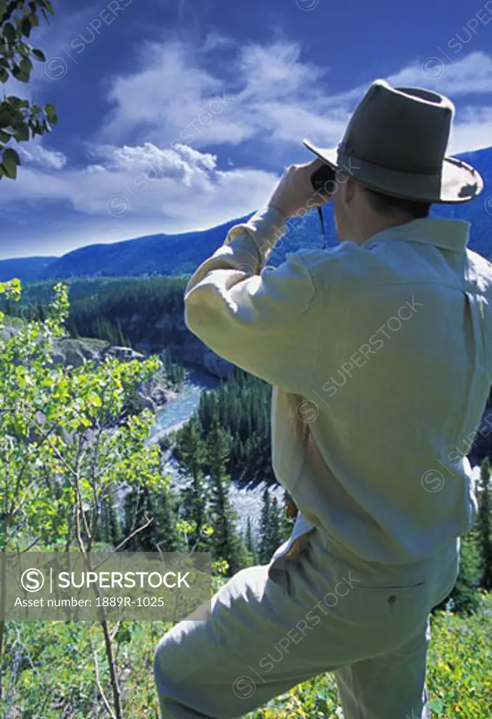 Hiker with binoculars enjoying view