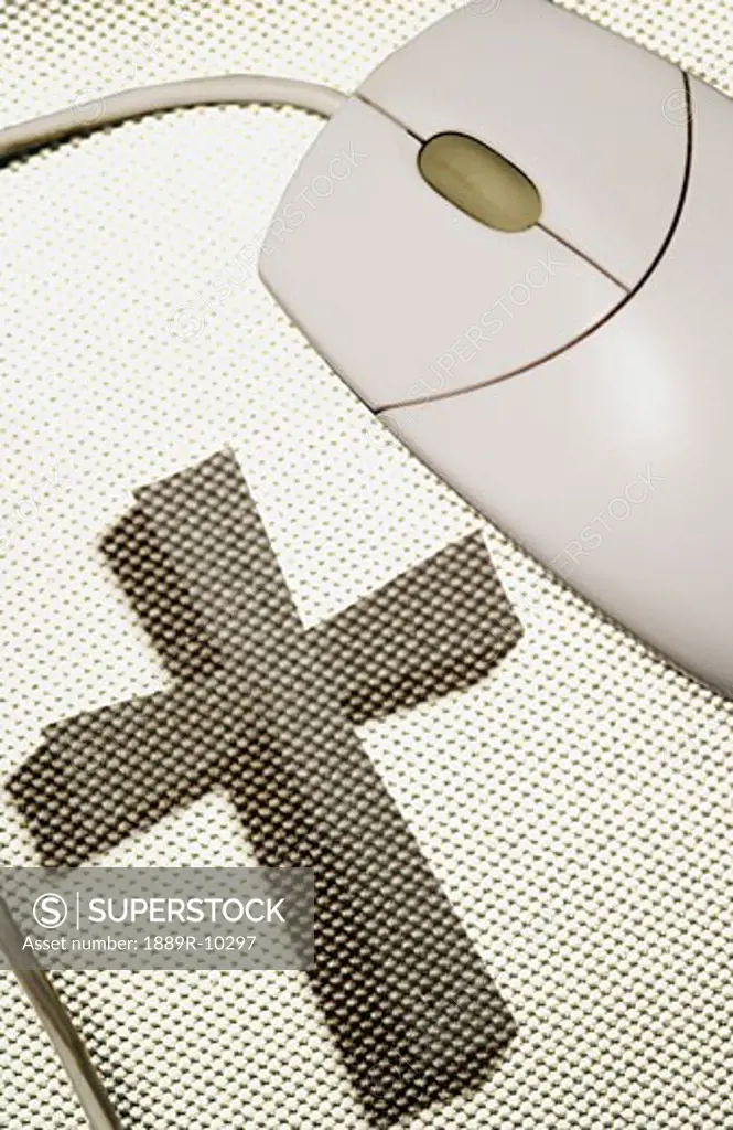 Computer mouse and cross on mouse pad