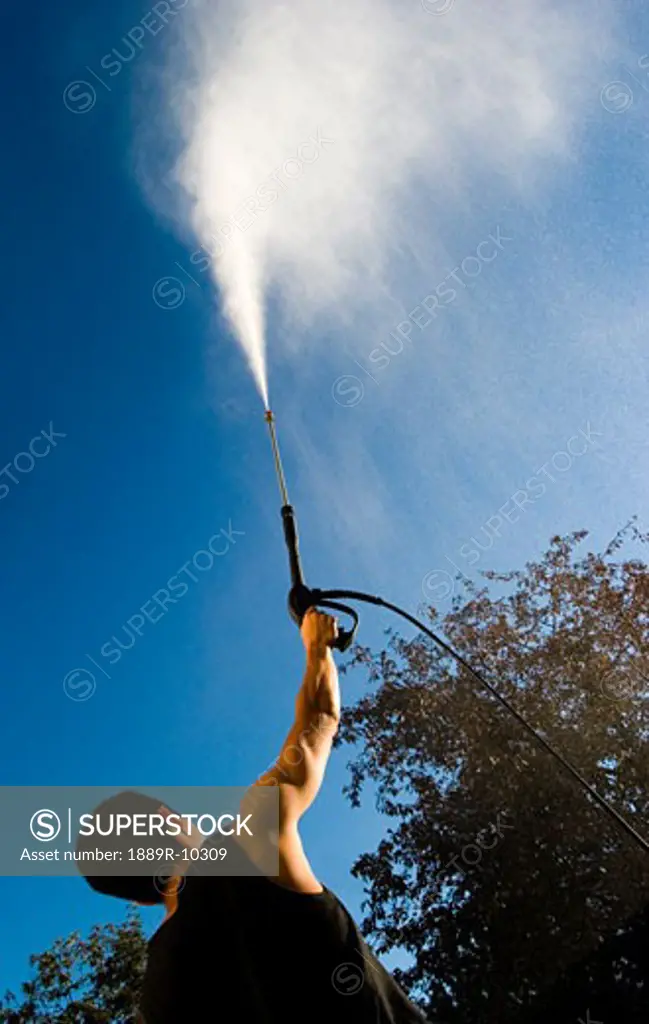 Man with pressure washer