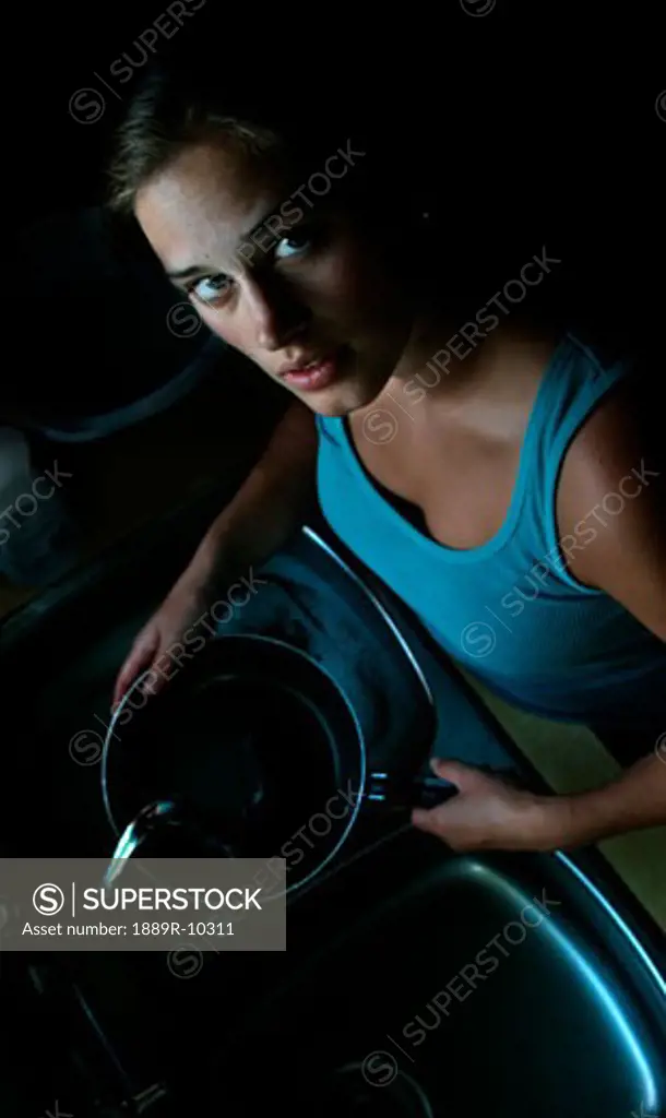 Woman standing at sink