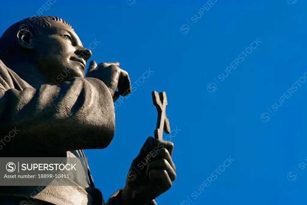 Statue holding cross