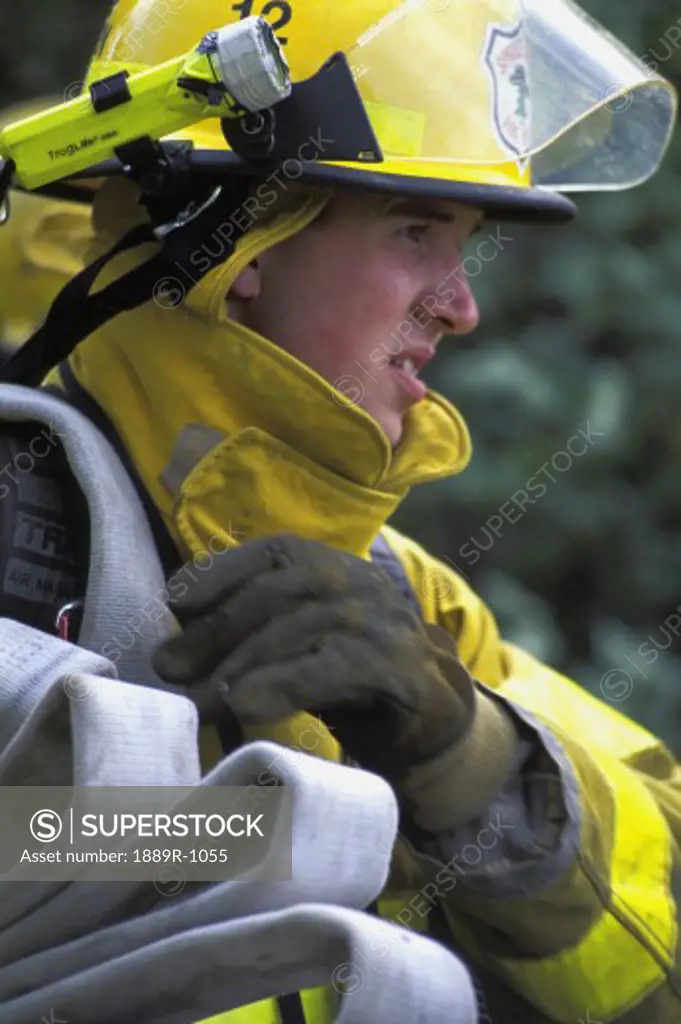Fireman carrying empty hose