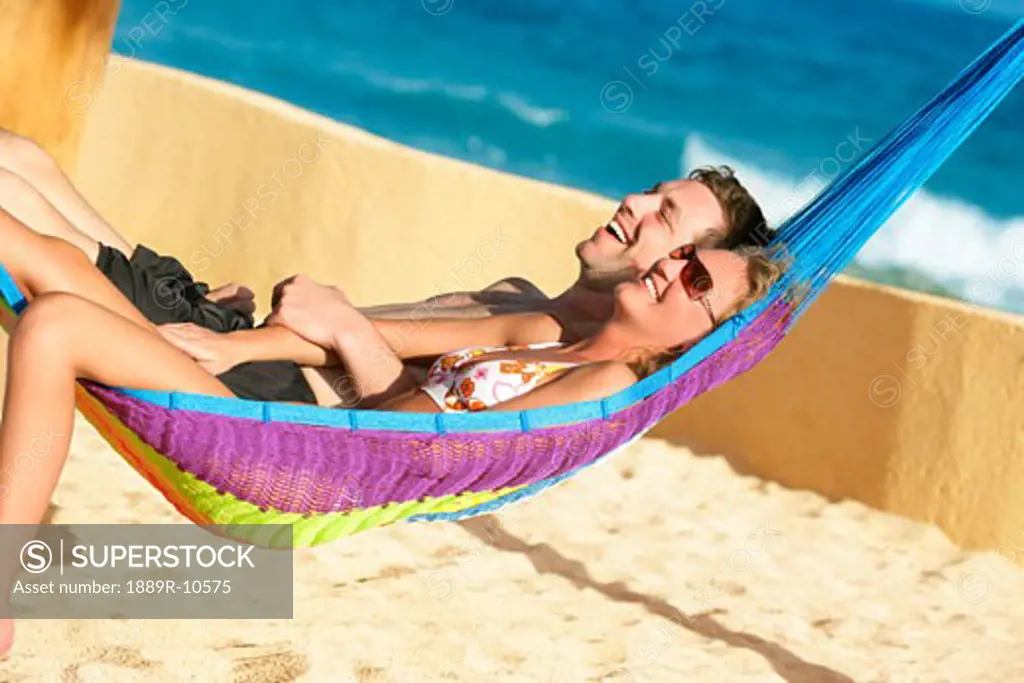 Happy couple in beach hammock
