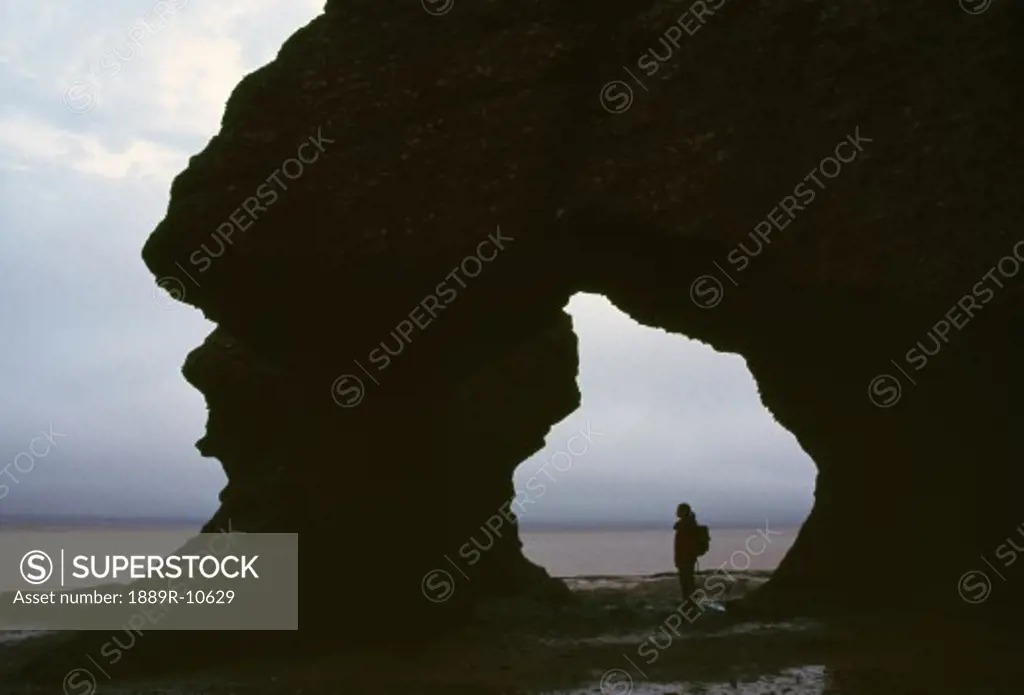 Silhouette of hiker at Hopewell Rocks, Bay of Fundy