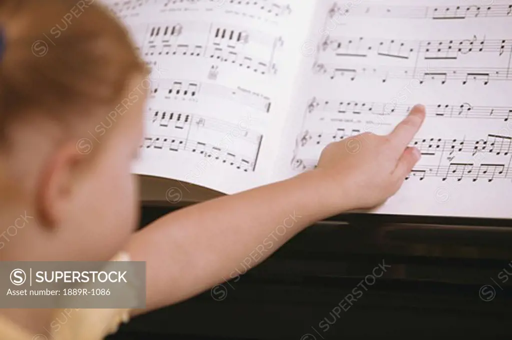 Child learns to play the piano