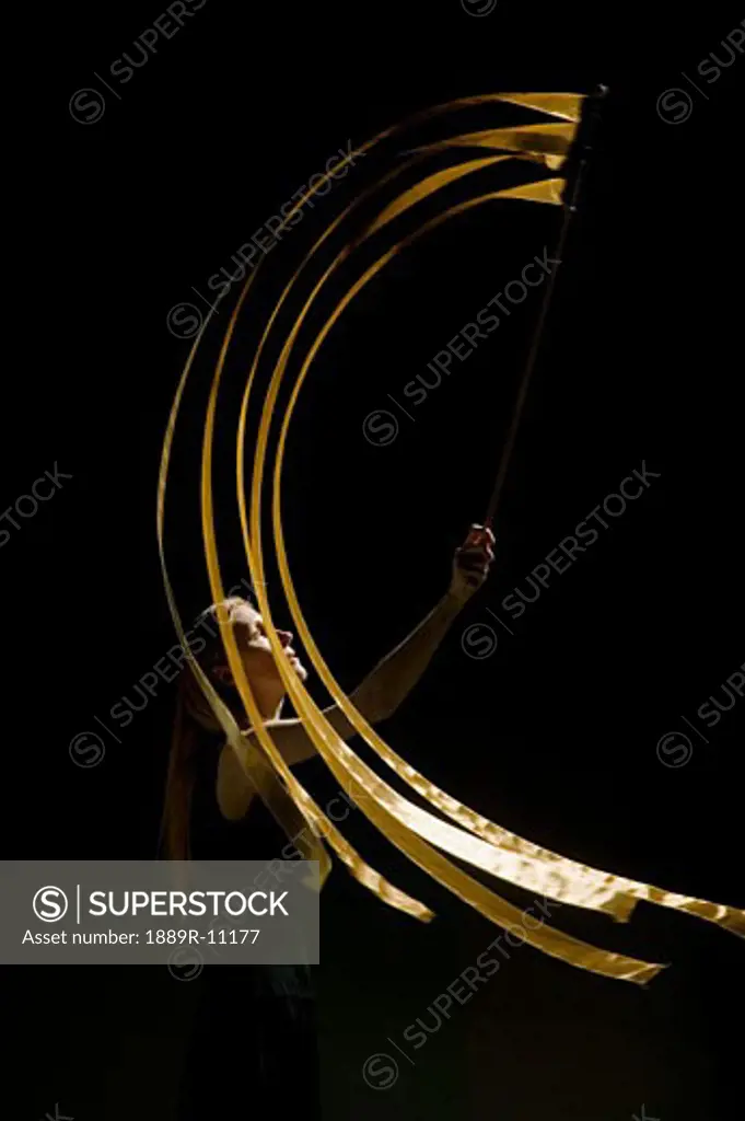 Woman waving flag in black background