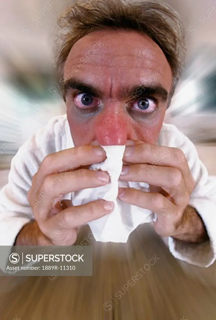 Man blowing nose  