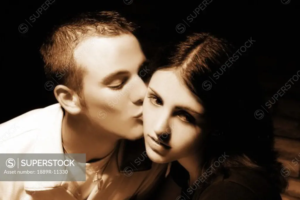 Teenage boy kissing teenage girl
