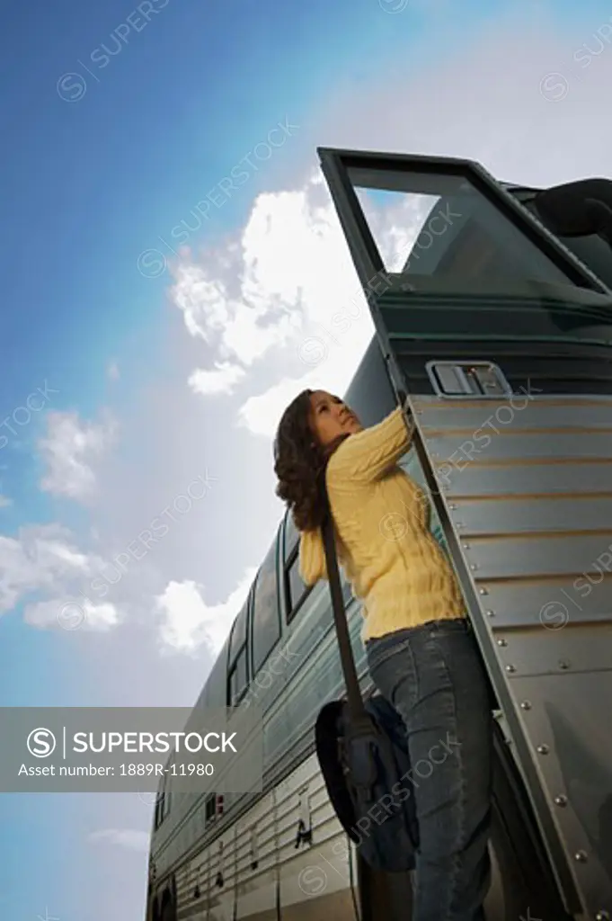 Woman climbing on a bus