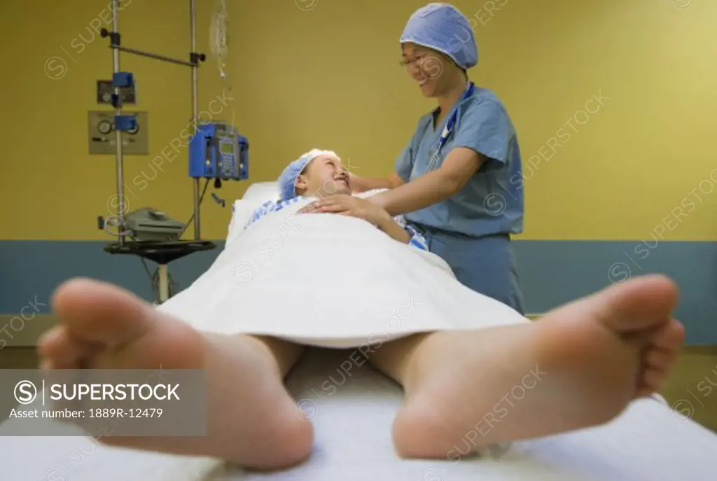 Female patient on an operating table under a doctor's supervision