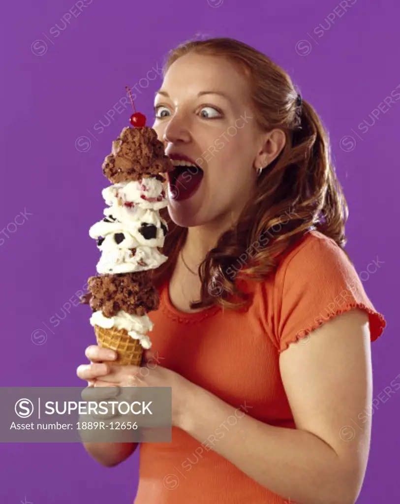 Girl eating a large ice cream cone  