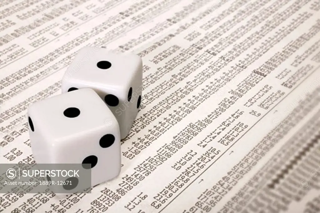 Dice on the stock market section of a newspaper