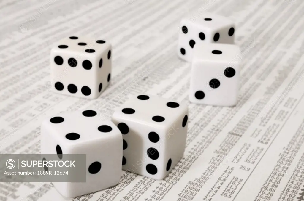 Dice on the stock market section of the newspaper