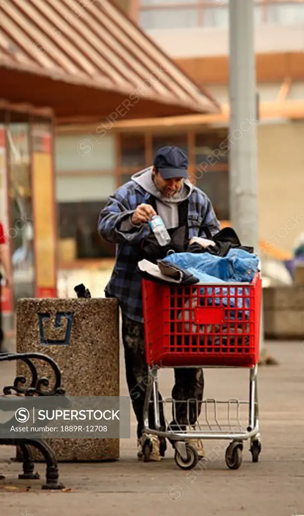 Homeless man picking through the garbage