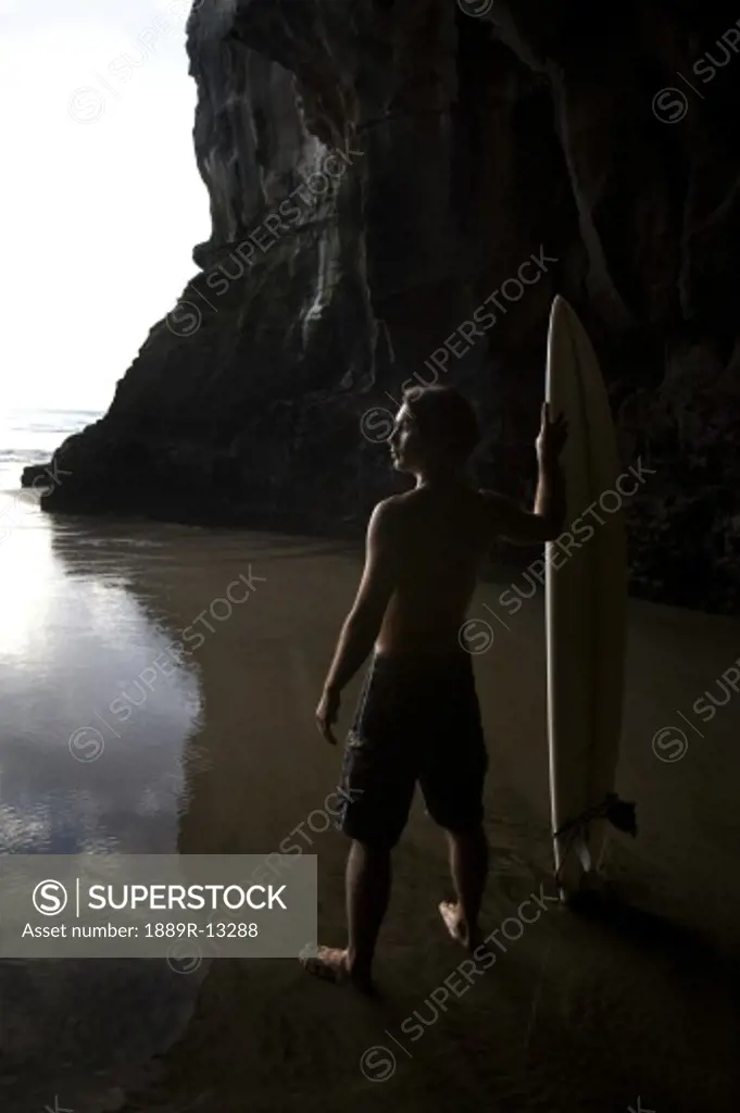 Surfer at Muriwai, New Zealand