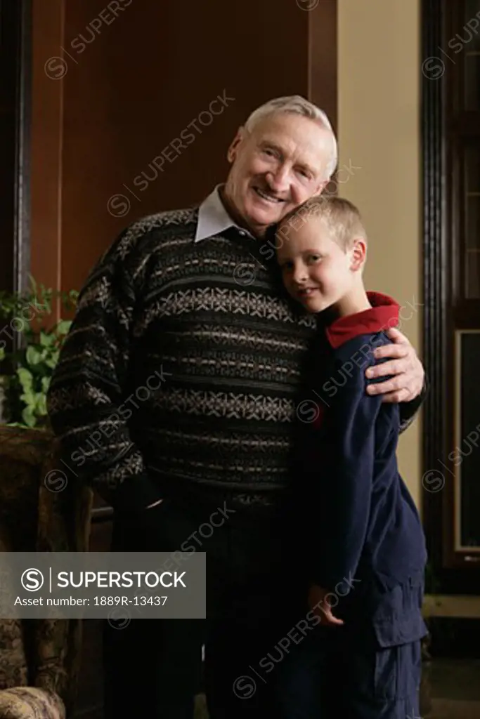 Grandfather hugging grandson