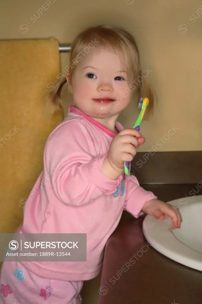 Little Girl Trying To Brush Her Teeth