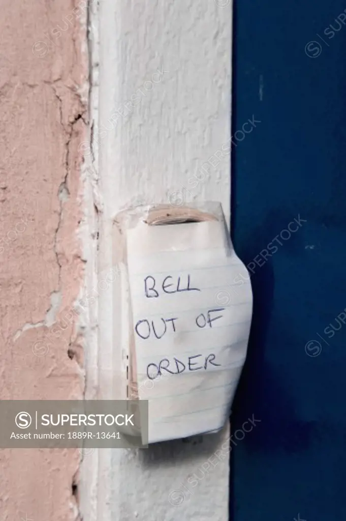 Hand printed note saying 'bell out of order'  