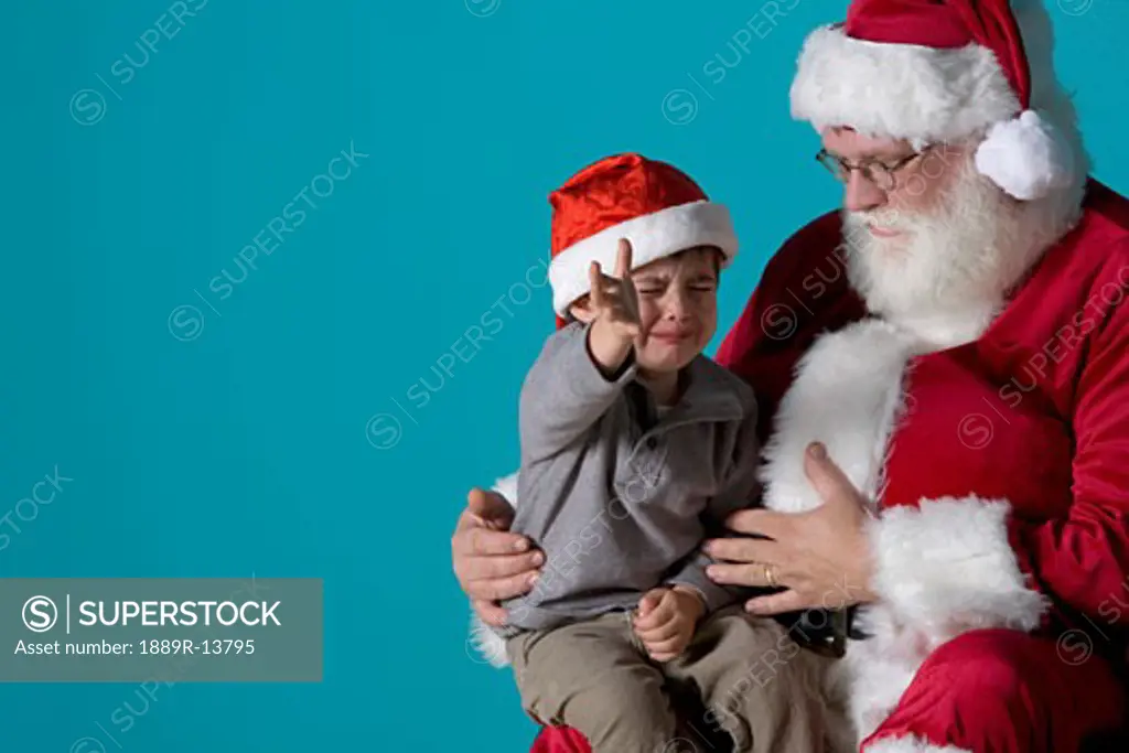 Little boy crying on Santa's lap