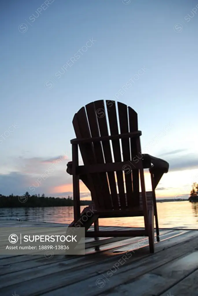 Lake of the Woods, Ontario; Lounge chair on dock