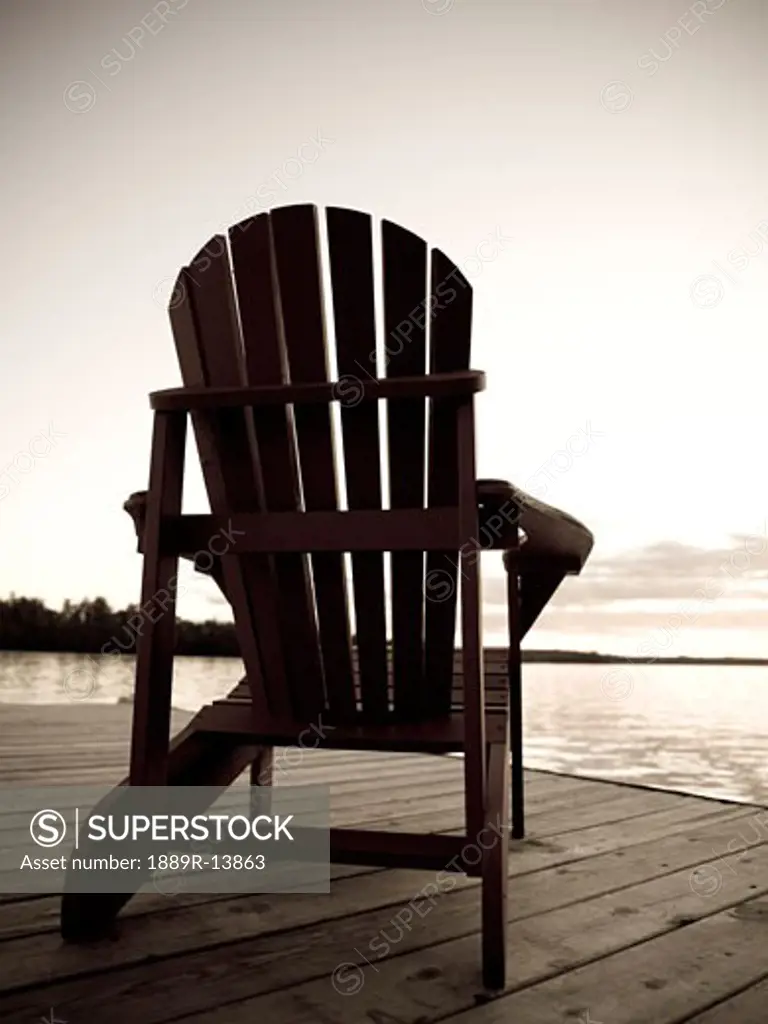 Lake of the Woods, Ontario, Canada;  Adirondack chair on a dock