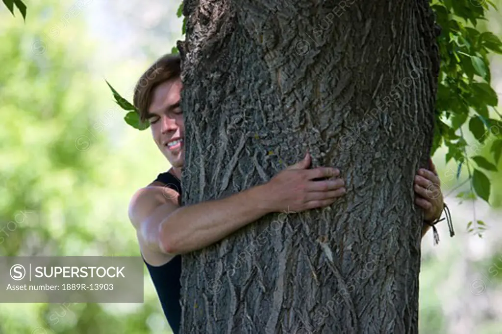 Man hugging a tree
