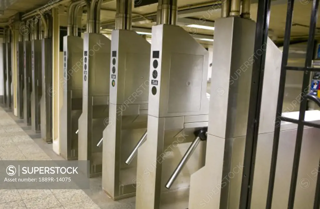 Manhattan, New York; Row of subway turnstiles