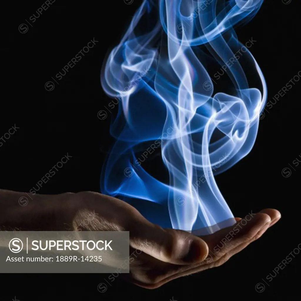 Smoke wisps from a hand