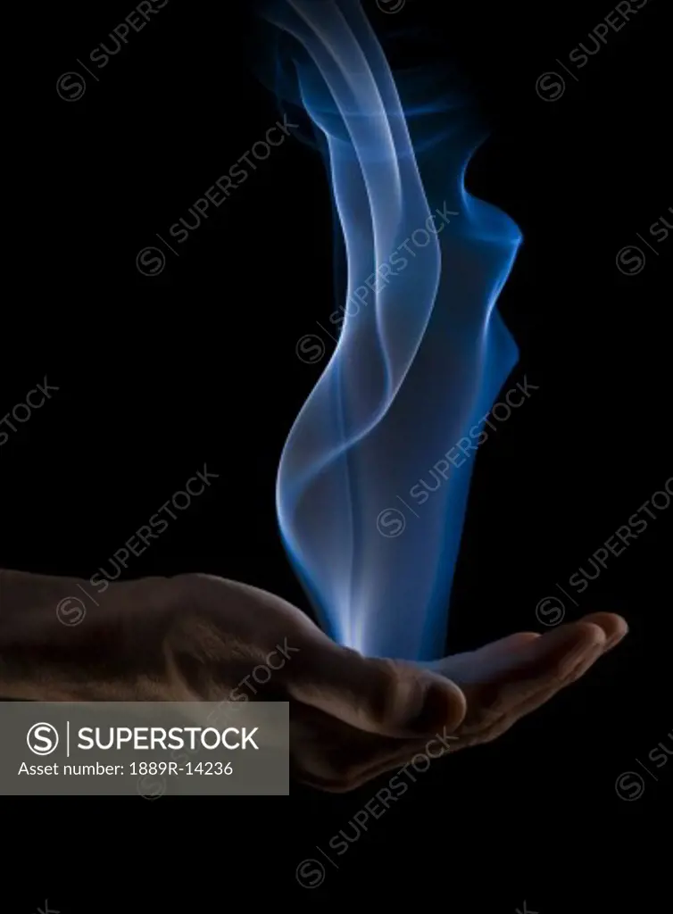 Smoke wisps from a hand