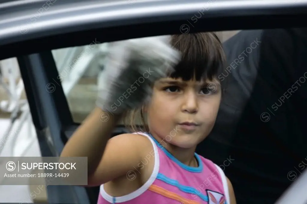 Girl cleaning car window