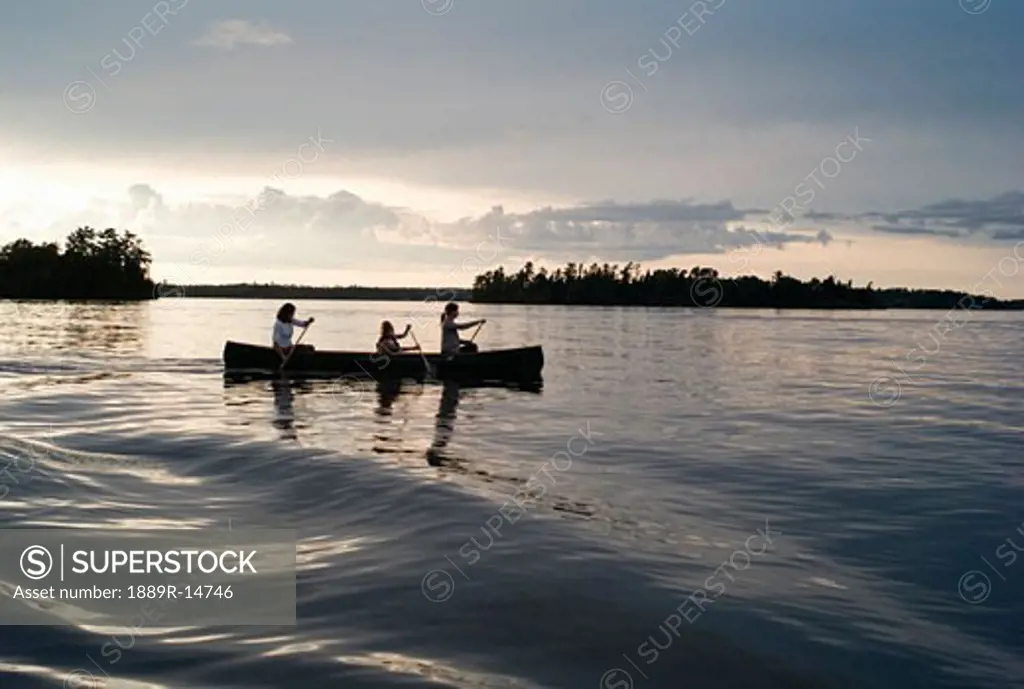 Lake of the Woods, Ontario, Canada; family in a canoe  