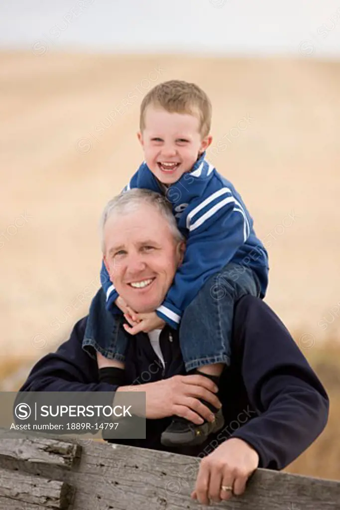 Father and son; Boy on his father's shoulders