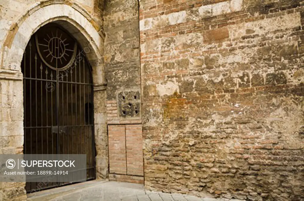 Gated stone wall, Siena, Tuscany, Italy