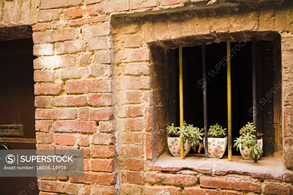 Window in stone wall, Siena, Italy