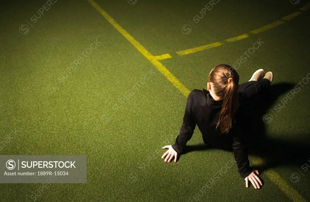 Girl sitting on the sidelines