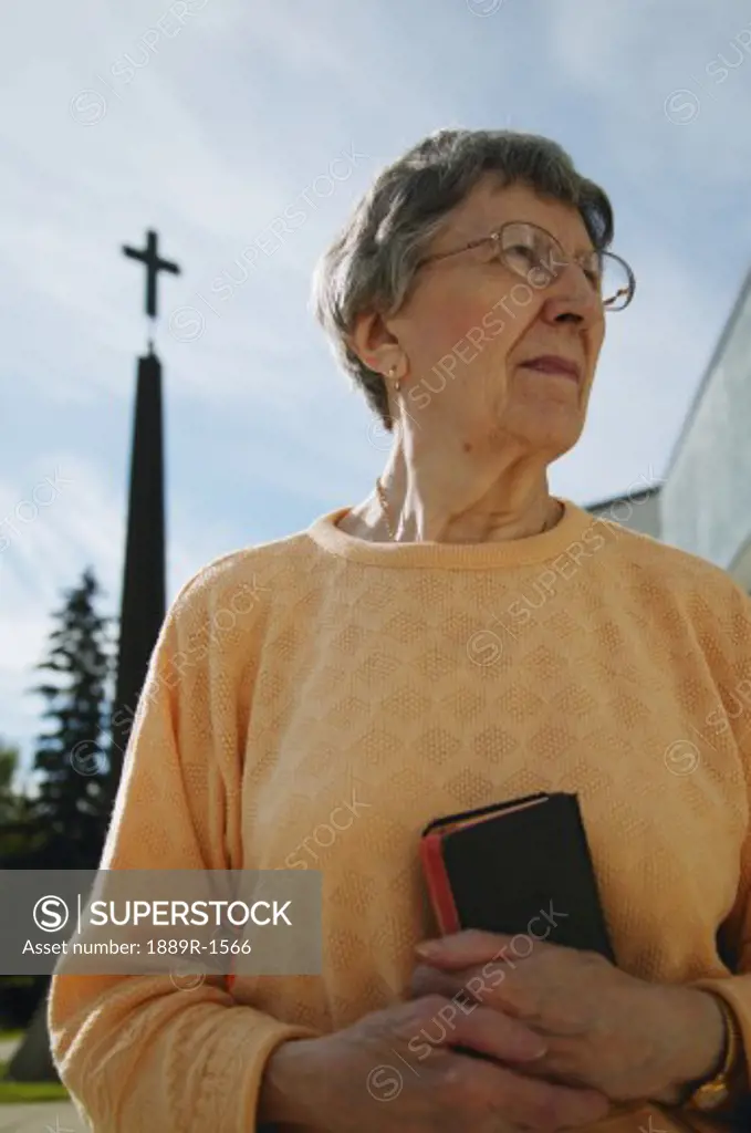 Woman holding bible in hand