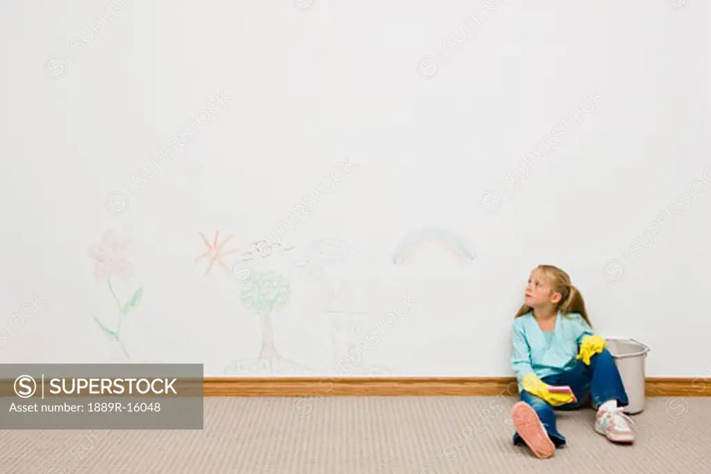 Girl cleaning drawing on the wall