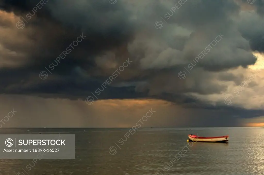North Sea, Sunderland, Tyne and Wear, England; Dark clouds and lone boat