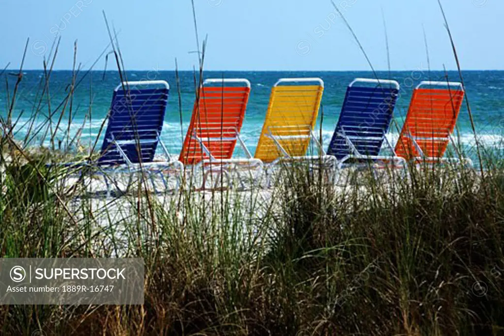 Bradenton Beach, Florida, USA; beach chairs lined on beach