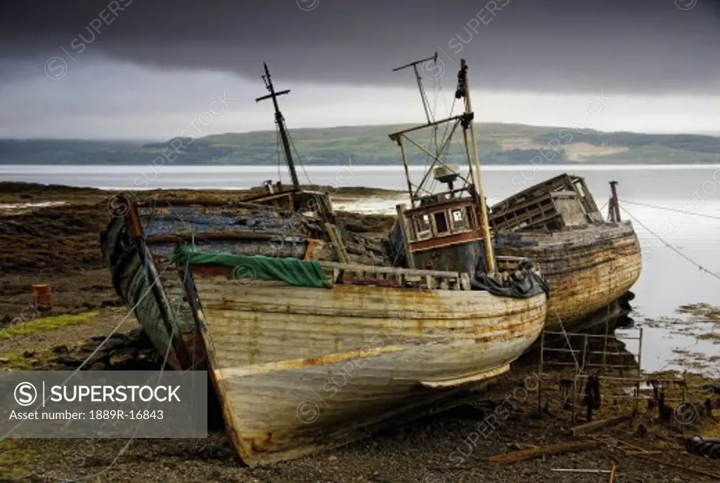 Scotland; Three boats on shore